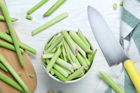 Flat lay composition with fresh lemongrass stalks on white wooden tableの写真素材