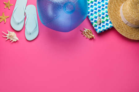 Flat lay composition with ball and beach objects on pink background, space for textの写真素材