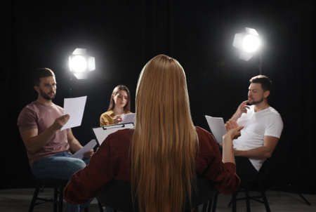 Professional actors reading their scripts during rehearsal in theaterの写真素材