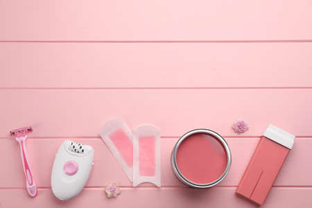 Set of epilation products on pink wooden table, flat lay. Space for textの写真素材