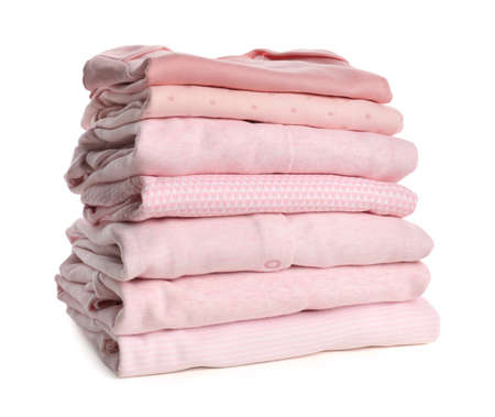 Stack of baby girl's clothes on white backgroundの写真素材