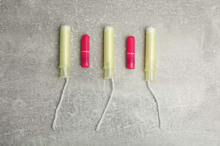 Tampons on gray background, flat lay. Menstrual hygiene product
