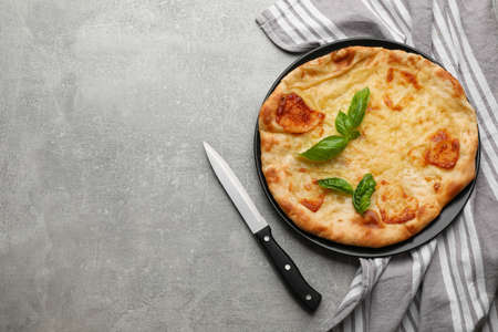 Delicious khachapuri with cheese on gray table, flat lay. Space for textの写真素材