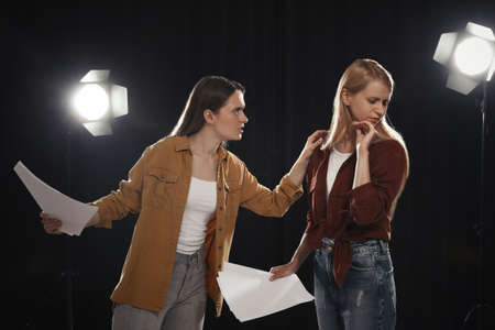 Professional actresses rehearsing on stage in theater