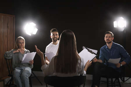 Professional actors reading their scripts during rehearsal in theaterの写真素材