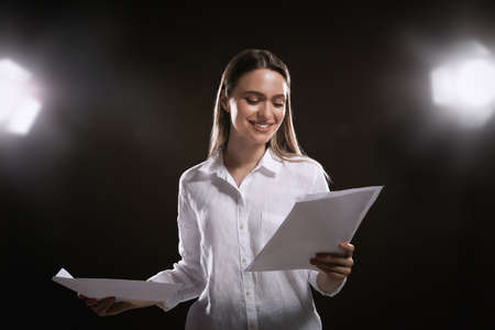Professional actress reading her script during rehearsal in theaterの写真素材
