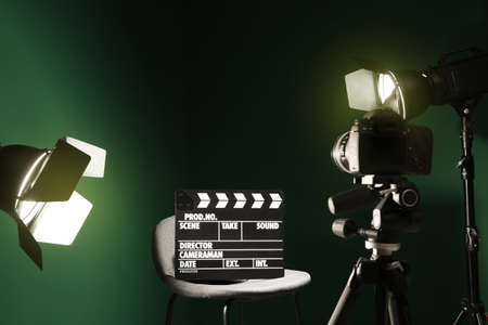 Chair with clapperboard under spotlight in studioの写真素材