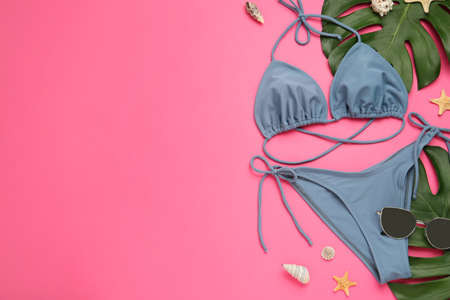 Flat lay composition with stylish bikini on pink background. Space for textの写真素材