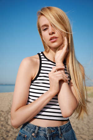 Beautiful young woman near sea on sunny day in summerの写真素材