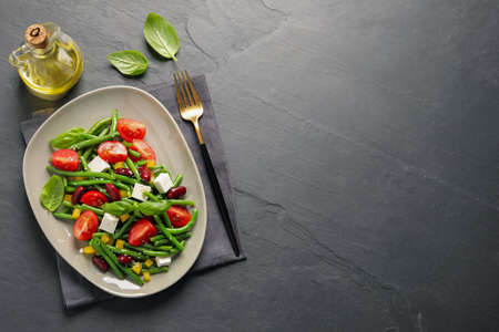 Tasty salad with green beans served on black table, flat lay. Space for textの写真素材