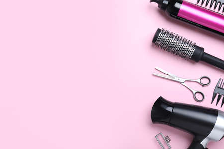 Professional hairdresser scissors and other equipment on pink background, flat lay with space for text. Haircut toolsの写真素材