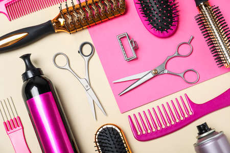 Flat lay composition of professional scissors and other hairdresser's equipment on color background. Haircut toolの写真素材