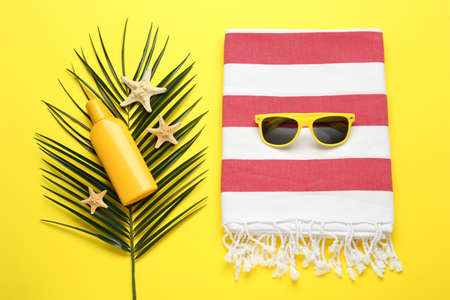 Flat lay composition with different beach objects on yellow backgroundの写真素材