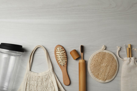 Flat lay composition with eco friendly products on white wooden background, space for text. Conscious consumptionの写真素材