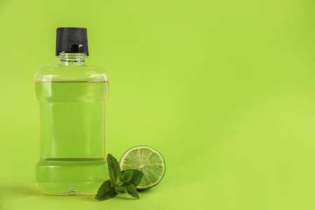 Mouthwash, fresh mint and lime on light green background. Space for textの写真素材