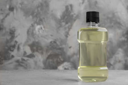 Mouthwash on gray table, space for textの写真素材
