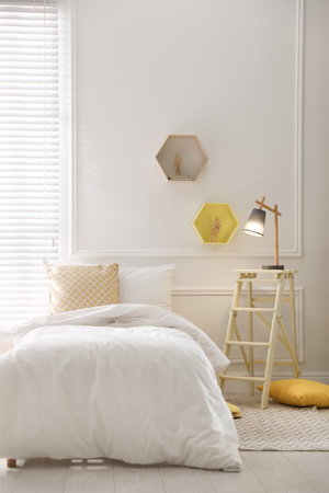 Comfortable bed with clean white linens indoorsの写真素材