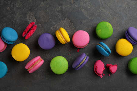 Different delicious macarons on gray table, flat layの写真素材