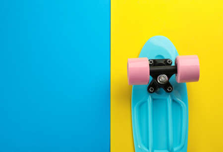Turquoise skateboard on color background, top view. Space for textの写真素材