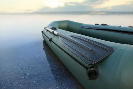 Inflatable rubber fishing boat at riverside, closeup. Space for textの写真素材