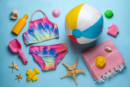 Flat lay composition with beach ball and sand toys on light blue backgroundの写真素材