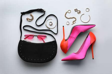 Stylish woman's bag, shoes, sunglasses and bijouterie on light background, flat layの写真素材
