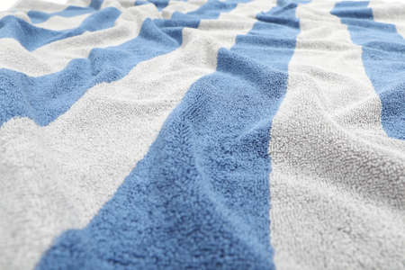 Crumpled striped beach towel as background, closeup viewの写真素材