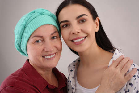 Young woman visiting her mother with cancer indoors