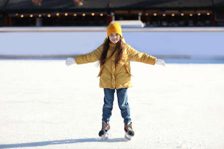 Cute little girl at outdoor ice skating rinkの写真素材