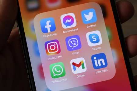 MYKOLAIV, UKRAINE - AUGUST 09, 2021: Woman holding smartphone with social media apps icons on screen, closeupのeditorial素材