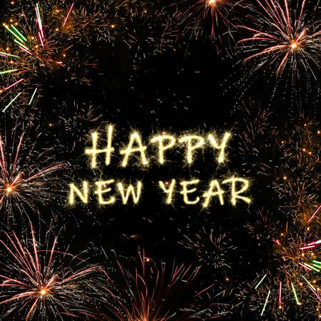 Bright text Happy New Year made of sparkler on black background. Greeting card designの写真素材