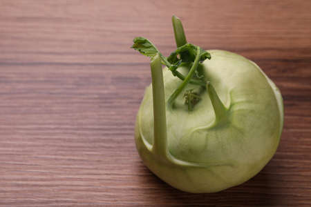 Whole ripe kohlrabi plant on wooden tableの写真素材
