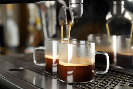 Making fresh aromatic espresso using professional coffee machineの写真素材