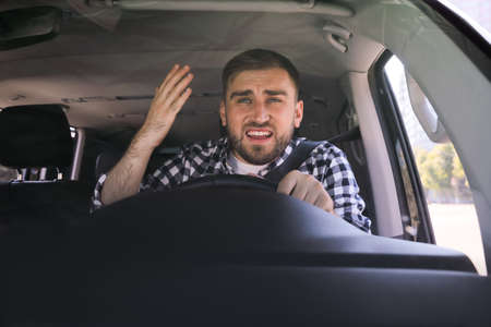 Emotional man in car. Aggressive driving behavior