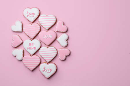 Delicious heart shaped cookies on pink background, flat lay. Space for textの写真素材