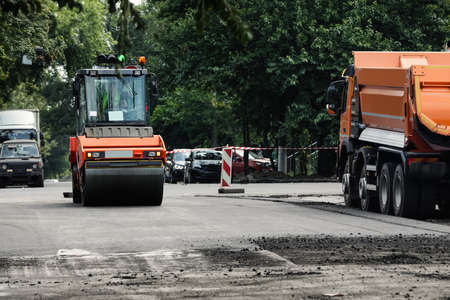 Road repair machinery working on city streetの写真素材
