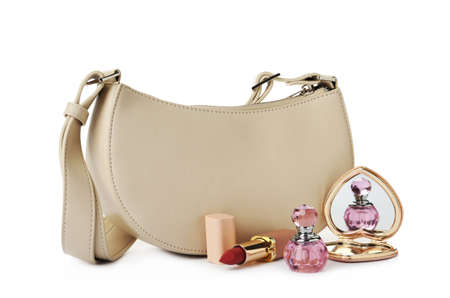 Stylish baguette bag with perfume, pocket mirror and lipstick on white backgroundの写真素材