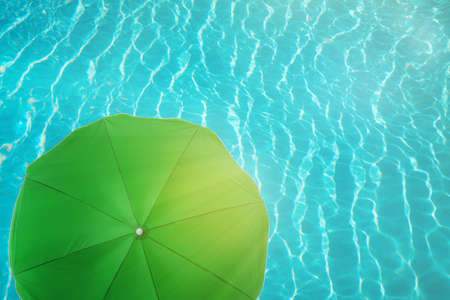 Open beach umbrella and swimming pool. Summer vacationの写真素材