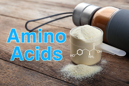 Measuring scoop of amino acids powder on wooden tableの写真素材