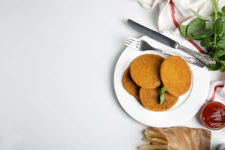 Delicious fried breaded cutlets served on white table, flat lay. Space for textの写真素材