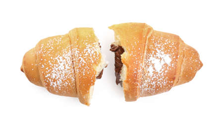 Halves of tasty croissant with chocolate and sugar powder on white background, top viewの写真素材