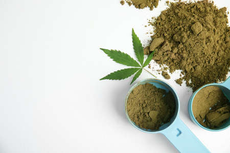 Hemp protein powder, fresh leaf and scoops on white background, top viewの写真素材