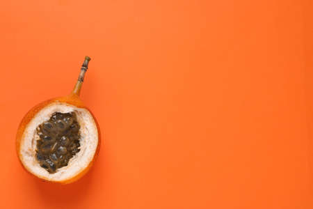 Delicious ripe granadilla on orange background, top view. Space for textの写真素材