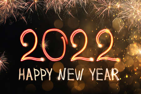 Bright text Happy New 2022 Year made of firework on dark background. Greeting card design