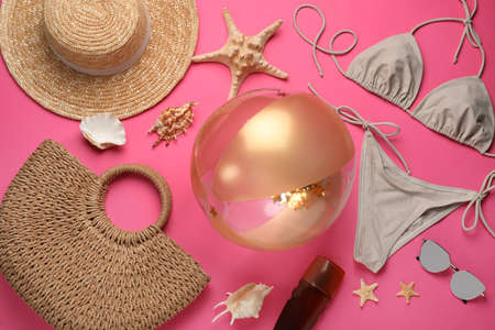 Flat lay composition with ball and beach objects on pink backgroundの写真素材