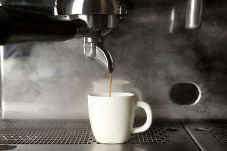 Making fresh aromatic espresso using professional coffee machineの写真素材