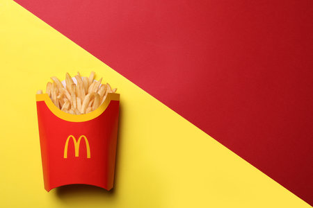 MYKOLAIV, UKRAINE - AUGUST 12, 2021: Big portion of McDonald's French fries on color background, top view. Space for textのeditorial素材