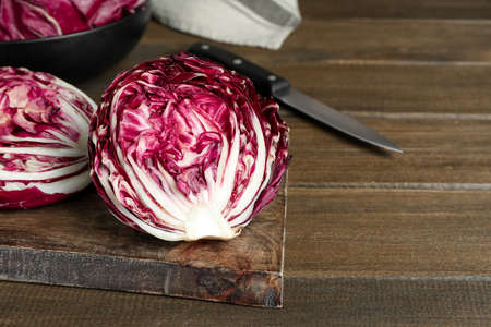Halves of fresh ripe radicchio on wooden table, space for textの写真素材