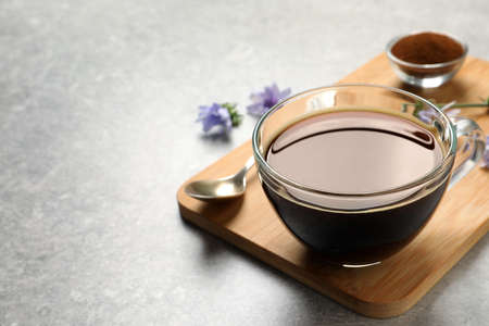 Glass cup of delicious chicory drink on light gray table, closeup. Space for textの写真素材