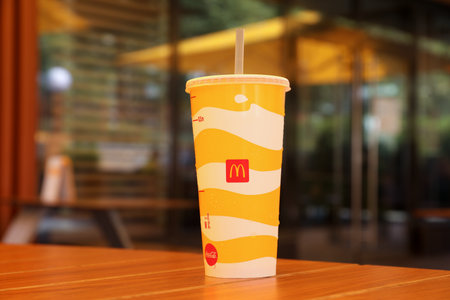 MYKOLAIV, UKRAINE - AUGUST 11, 2021: Cold McDonald's drink on table in cafeのeditorial素材